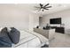 Spacious bedroom featuring a comfortable seating area, plush bed, and a sleek entertainment center with a large TV at 8575 Nicholas James Ave, Las Vegas, NV 89143