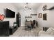 Stylish home office with a modern desk, comfortable seating, and a large wall-mounted television for convenience at 8575 Nicholas James Ave, Las Vegas, NV 89143