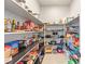 Well-organized pantry with ample shelving, showcasing various food items and kitchen supplies for convenient storage at 8575 Nicholas James Ave, Las Vegas, NV 89143