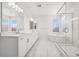 Elegant bathroom features dual sinks, soaking tub, glass shower and plantation shutters at 8591 Cloudy Dawn Way, Las Vegas, NV 89113
