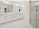 Elegant bathroom with a double vanity, large mirror, and glass-enclosed shower at 8591 Cloudy Dawn Way, Las Vegas, NV 89113
