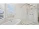 Modern bathroom with a glass shower and soaking tub at 8591 Cloudy Dawn Way, Las Vegas, NV 89113