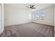 Bright bedroom with modern ceiling fan and view from shuttered windows at 8591 Cloudy Dawn Way, Las Vegas, NV 89113