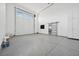 A large three car garage with epoxy floors and a sliding door entrance at 8591 Cloudy Dawn Way, Las Vegas, NV 89113
