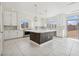 Spacious kitchen featuring a large island, white cabinets, and modern stainless steel appliances at 8591 Cloudy Dawn Way, Las Vegas, NV 89113