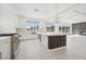 Spacious kitchen with a large island, stainless steel appliances, modern lighting, and a seamless transition to the living area at 8591 Cloudy Dawn Way, Las Vegas, NV 89113