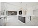 Open-concept kitchen with large island, white cabinets, and modern lighting at 8591 Cloudy Dawn Way, Las Vegas, NV 89113