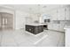 Modern kitchen with island, white cabinets, and stainless-steel appliances at 8591 Cloudy Dawn Way, Las Vegas, NV 89113