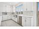 Bright kitchen with stainless steel sink, white cabinets, and marble backsplash at 8591 Cloudy Dawn Way, Las Vegas, NV 89113