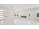 Open living room with tile floors, modern fireplace and plantation shutters for privacy at 8591 Cloudy Dawn Way, Las Vegas, NV 89113