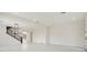 Open-concept living area featuring tile flooring, and modern staircase at 8591 Cloudy Dawn Way, Las Vegas, NV 89113