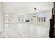 Spacious living room with a fireplace, white walls, and tile flooring at 8591 Cloudy Dawn Way, Las Vegas, NV 89113
