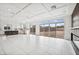 Open living room with tile flooring, modern kitchen, fireplace and sliding doors leading to yard at 8591 Cloudy Dawn Way, Las Vegas, NV 89113