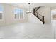 Living room features a modern light fixture, staircase, plantation shutters and tile floors at 8591 Cloudy Dawn Way, Las Vegas, NV 89113