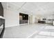 Open-concept living area with fireplace, bar, and white tile flooring at 8591 Cloudy Dawn Way, Las Vegas, NV 89113