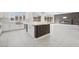 Bright living room with an open floor plan features modern lighting, a sleek fireplace, and access to the kitchen at 8591 Cloudy Dawn Way, Las Vegas, NV 89113