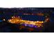 Aerial night shot showcasing a sparkling pool, landscaped yard, and illuminated outdoor spaces at 9117 Hickam Ave, Las Vegas, NV 89129