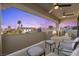 Spacious covered balcony with seating offers panoramic views of the neighborhood at dusk at 9117 Hickam Ave, Las Vegas, NV 89129