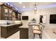 Custom bar area featuring stone accents, granite countertop, cabinetry and accent lighting at 9117 Hickam Ave, Las Vegas, NV 89129