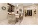 A stylish bar area with stone accents, comfortable seating, and seamless flow into the home's bright and airy entryway at 9117 Hickam Ave, Las Vegas, NV 89129