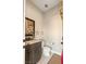 Bathroom with granite countertop, wood cabinetry, tiled floors and decorative stars at 9117 Hickam Ave, Las Vegas, NV 89129
