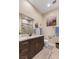 Beautiful bathroom featuring granite countertops, a modern vanity, and a spacious shower with contemporary tile at 9117 Hickam Ave, Las Vegas, NV 89129