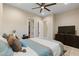 Cozy bedroom with plush bedding, neutral color palette, ceiling fan, and ensuite bathroom access at 9117 Hickam Ave, Las Vegas, NV 89129