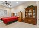 A cozy bedroom boasting a full-size bed, wood flooring, and custom shelving perfect for relaxation and storage at 9117 Hickam Ave, Las Vegas, NV 89129
