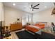 Well-lit bedroom with wooden furniture, neutral walls, and ceiling fan at 9117 Hickam Ave, Las Vegas, NV 89129