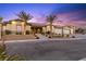 Stunning exterior view of the home featuring a manicured front yard and a welcoming entrance at twilight at 9117 Hickam Ave, Las Vegas, NV 89129