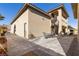 An elegant two-story home boasting a spiral staircase and a charming outdoor patio area for relaxing and entertaining at 9117 Hickam Ave, Las Vegas, NV 89129