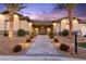 Charming single-story home with an inviting walkway, desert landscaping, and exterior lighting at 9117 Hickam Ave, Las Vegas, NV 89129