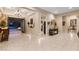 Elegant foyer with tiled floors, chandelier, and view of outdoor patio through glass doors at 9117 Hickam Ave, Las Vegas, NV 89129