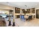 Open kitchen and living area with barstool seating, island, and access to the outdoor patio at 9117 Hickam Ave, Las Vegas, NV 89129