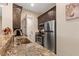 Modern kitchen with stainless steel appliances, granite countertops, and ample storage for a seamless cooking experience at 9117 Hickam Ave, Las Vegas, NV 89129