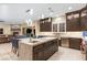 Gourmet kitchen featuring an island, stainless steel appliances, and seamlessly connected to living area at 9117 Hickam Ave, Las Vegas, NV 89129