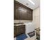 Convenient laundry room with ample cabinet space and countertop area with modern appliances at 9117 Hickam Ave, Las Vegas, NV 89129