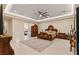 Bright primary bedroom features a tray ceiling, elegant furnishings, and a partial view of an en-suite bathroom at 9117 Hickam Ave, Las Vegas, NV 89129