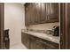 Well-organized pantry with ample storage space, granite countertop, and a beverage station at 9117 Hickam Ave, Las Vegas, NV 89129