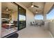 Covered patio with seating area offering mountain views through sliding glass door at 9117 Hickam Ave, Las Vegas, NV 89129