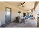 Covered patio with ceiling fans, outdoor dining set and exterior kitchen at 9117 Hickam Ave, Las Vegas, NV 89129