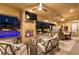 Covered patio with a cozy fireplace, comfortable seating, and views of the sparkling pool at 9117 Hickam Ave, Las Vegas, NV 89129