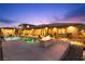 Backyard oasis with a sparkling pool, spa, fire pit, and lush landscaping at 9117 Hickam Ave, Las Vegas, NV 89129