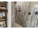 Luxurious walk-in shower with designer tile, dual shower heads, and built-in shelving, blending style and functionality at 9117 Hickam Ave, Las Vegas, NV 89129