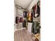 Organized walk-in closet with ample storage solutions, including shelves and hanging rods at 9117 Hickam Ave, Las Vegas, NV 89129