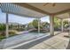 Spacious covered back patio with manicured landscaping and lovely neighborhood view at 10235 Tresor Ct, Las Vegas, NV 89135
