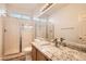 Bathroom featuring granite countertops, glass shower, and modern fixtures at 10235 Tresor Ct, Las Vegas, NV 89135