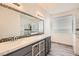 Bathroom with dual sinks, decorative mirror and a separate glass shower at 10235 Tresor Ct, Las Vegas, NV 89135