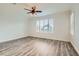 Light and airy bedroom with ceiling fan, wood-look floors, and plantation shutters at 10235 Tresor Ct, Las Vegas, NV 89135