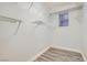 Bright walk-in closet with white walls, wood floor, wire shelving and window at 10235 Tresor Ct, Las Vegas, NV 89135